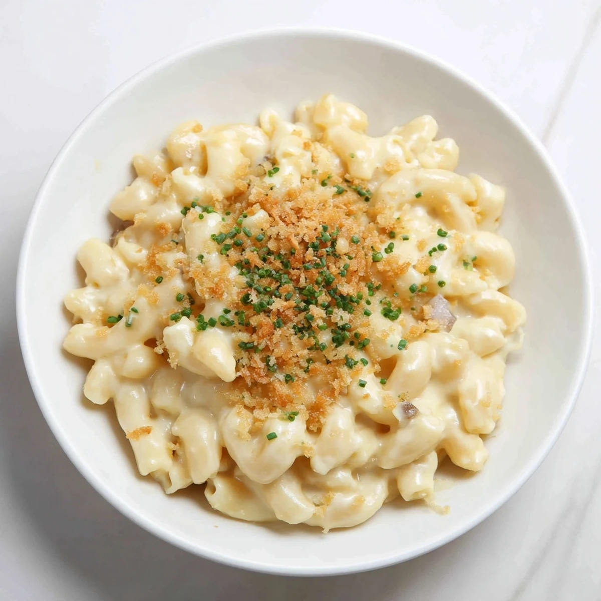 A close-up of creamy Stove-Top Mac and Cheese, garnished with fresh chives, ready to eat.