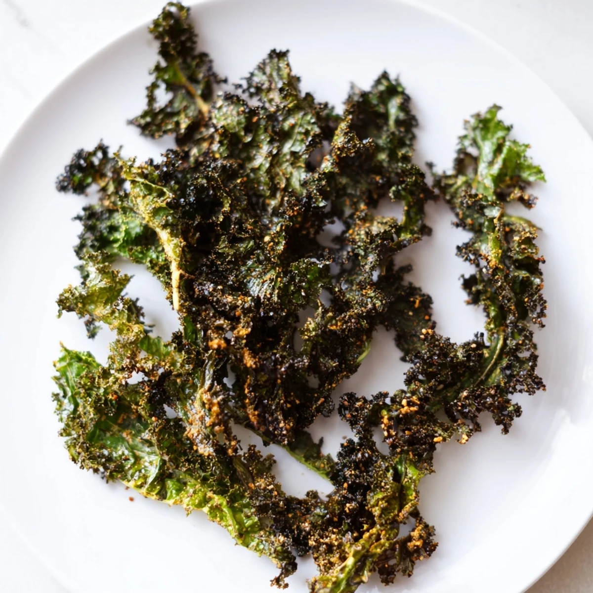 Golden-brown, crispy kale chips baked to perfection, a healthy and delightful snack bursting with flavor.