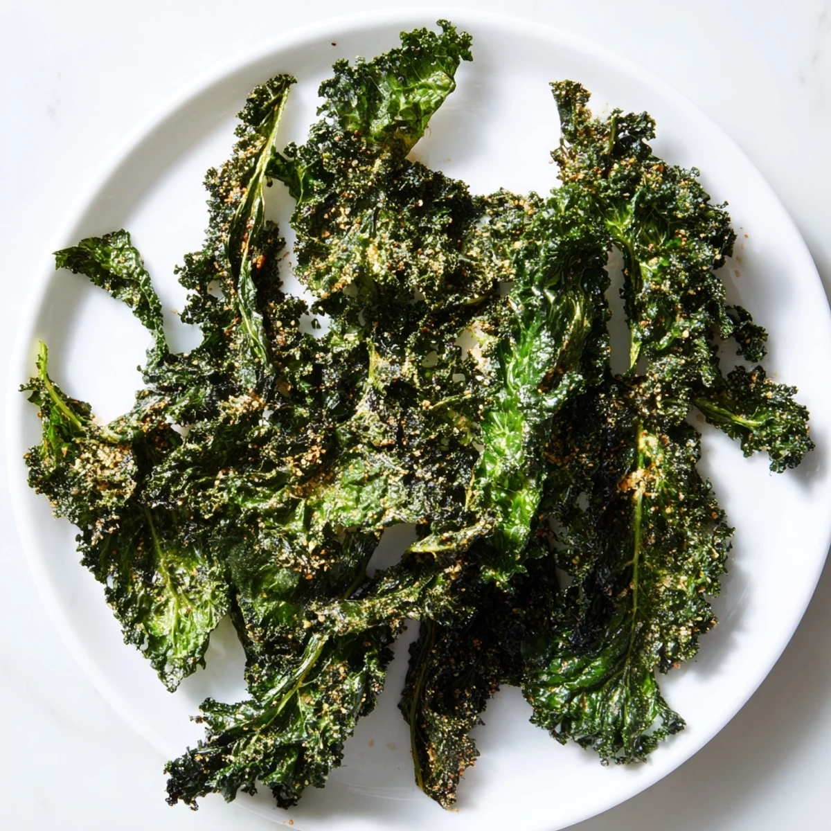 Freshly baked crispy kale chips, appearing wonderfully textured and seasoned for your healthy snack enjoyment.