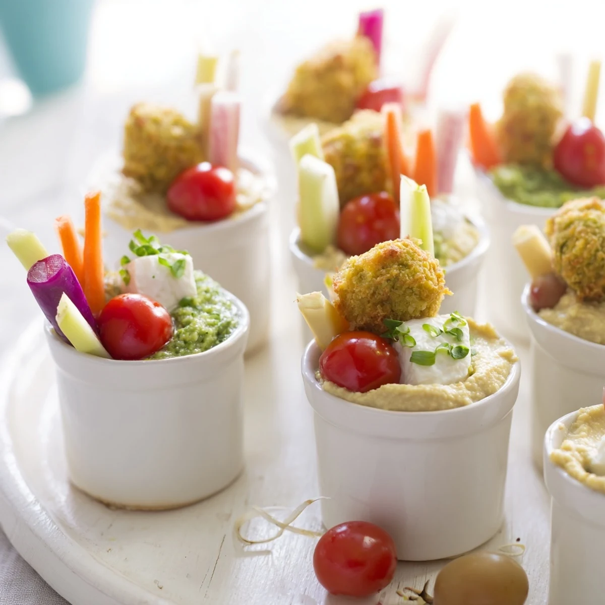 Vibrant The Hanging Gardens appetizer arrangement showcasing fresh vegetables, fruits, and creamy goat cheese for serving.