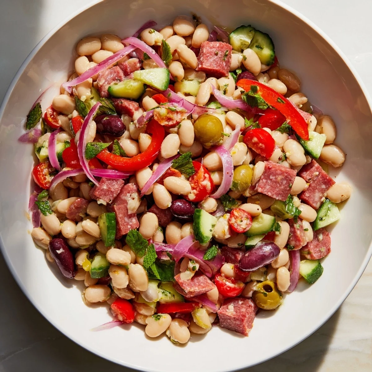 Close-up of Mediterranean Dense Bean Salad with Salami, ready to be enjoyed as a refreshing lunch.