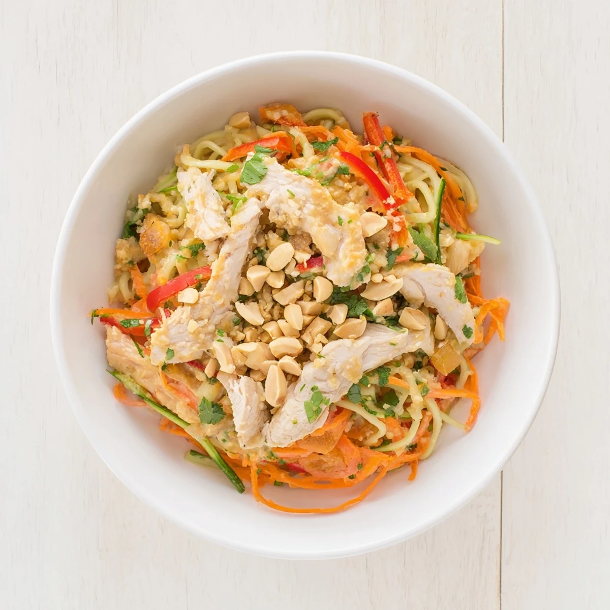 This close-up shot of Thai-Inspired Peanut Chicken Pasta shows a perfect blend of flavors and textures ready to eat.