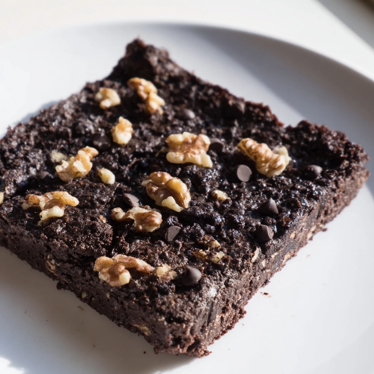 Warm, gooey black bean brownies with melted chocolate chips, perfect for a gluten-free dessert.
