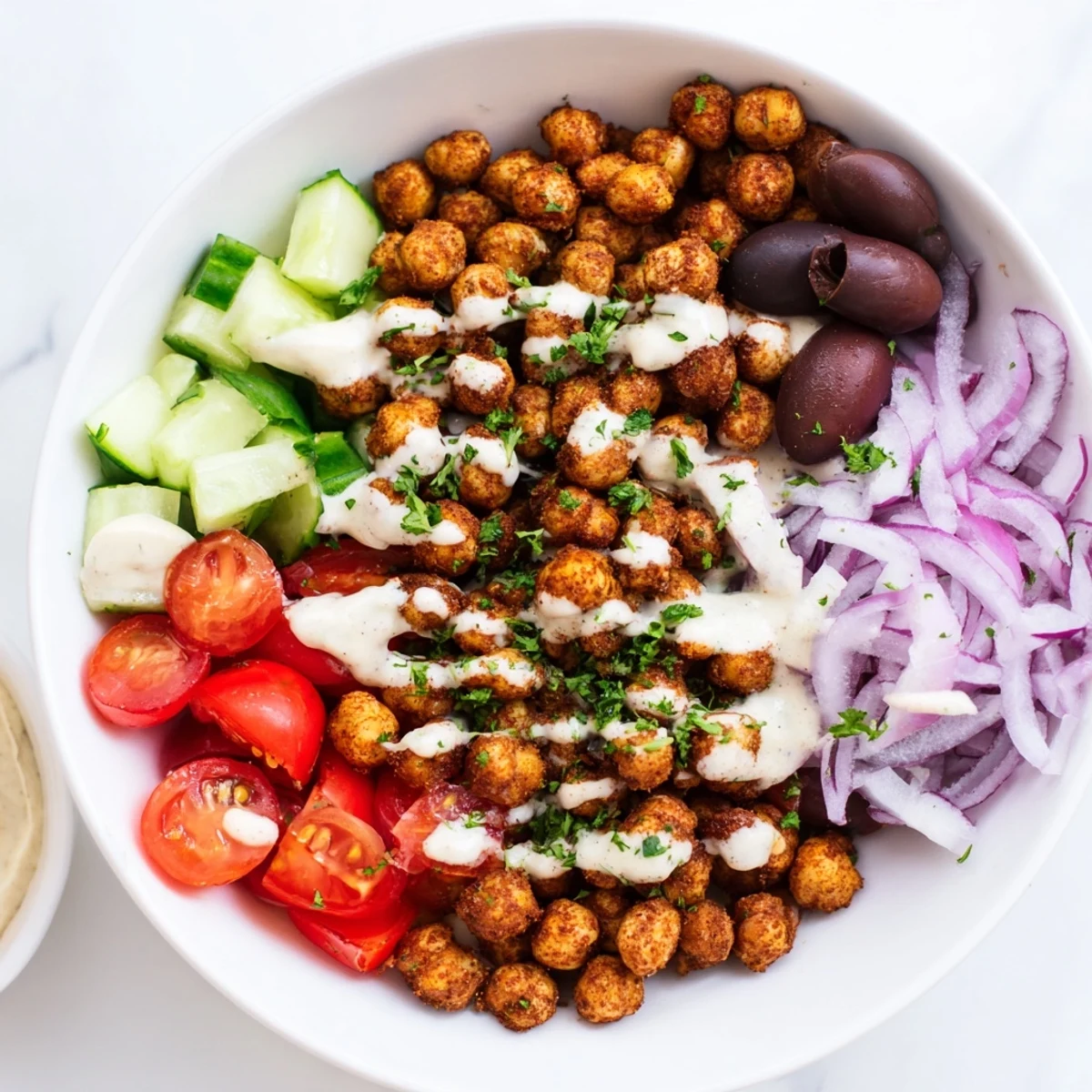 Vibrant Mediterranean Chickpea Bowl, featuring crispy chickpeas, juicy tomatoes, and a creamy tahini sauce, all delicious.