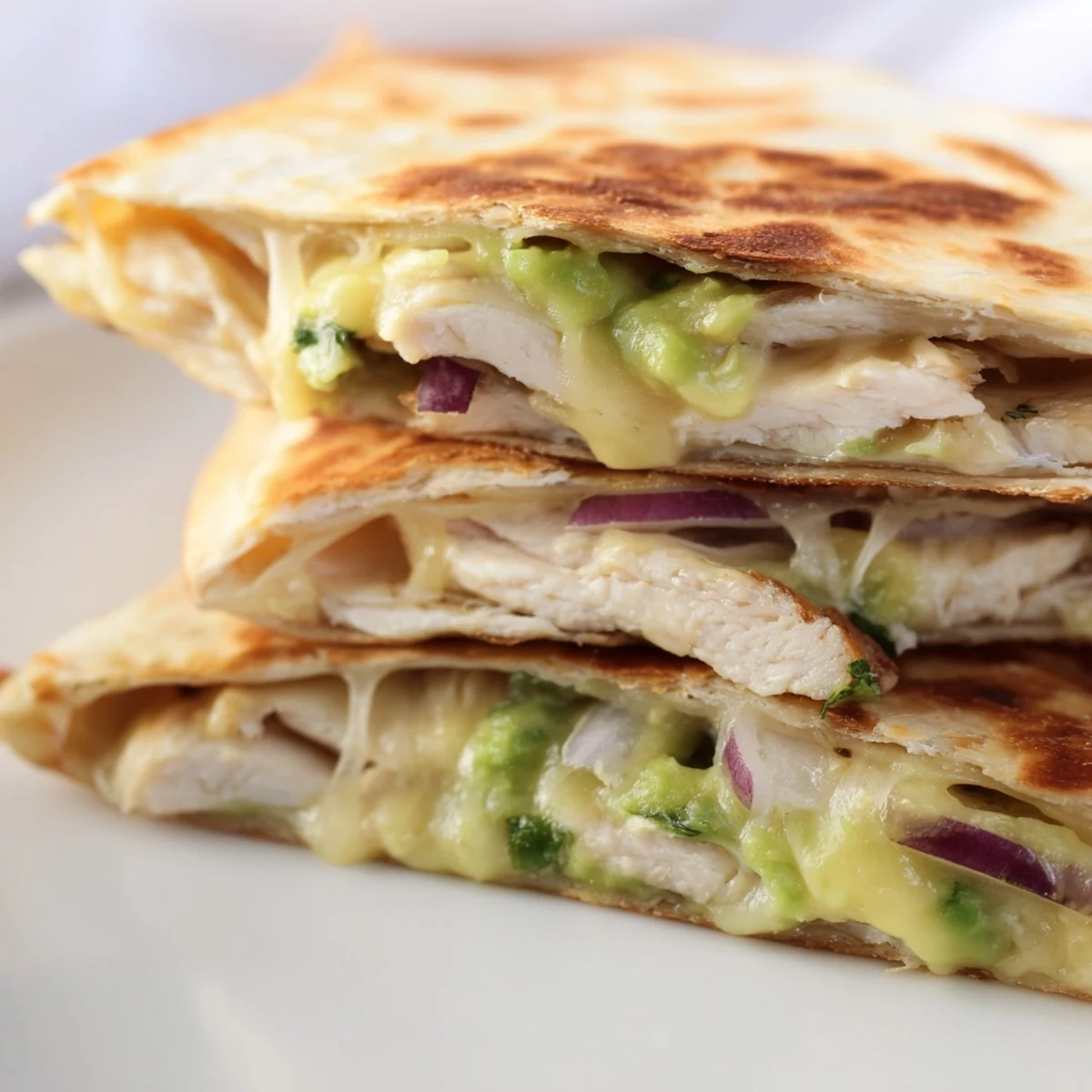Freshly grilled Chicken Avocado Quesadilla served with a side of salsa and sour cream for dipping.