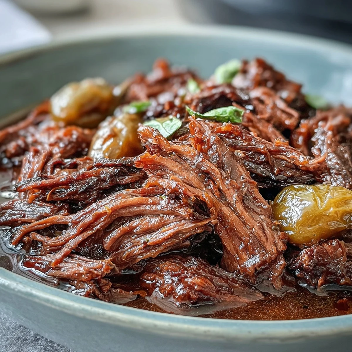 Slow Cooker Mississippi-Style Ranch Beef served over creamy mashed potatoes with a pat of butter and a drizzle of rich, savory juices.