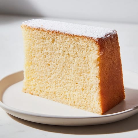 Fluffy slices of simple 3-ingredient vanilla sponge cake, showing a golden crust and airy texture.