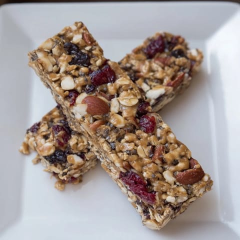 Golden-brown No-Bake Energy Bars, studded with nuts and dried fruit, ready for a delicious snack.