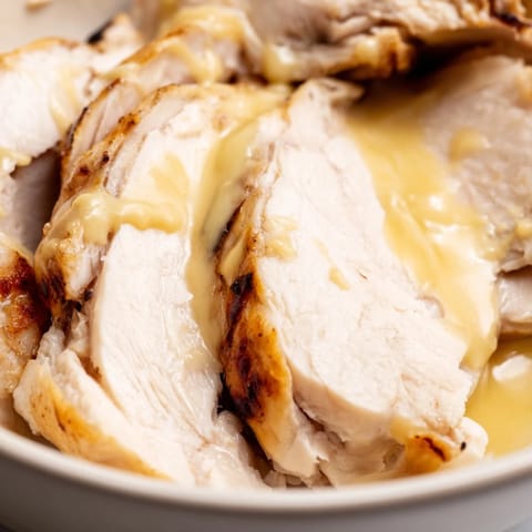 Golden roasted chicken and crispy chickpeas are layered over farro and greens, all drizzled with creamy lemon tahini dressing.