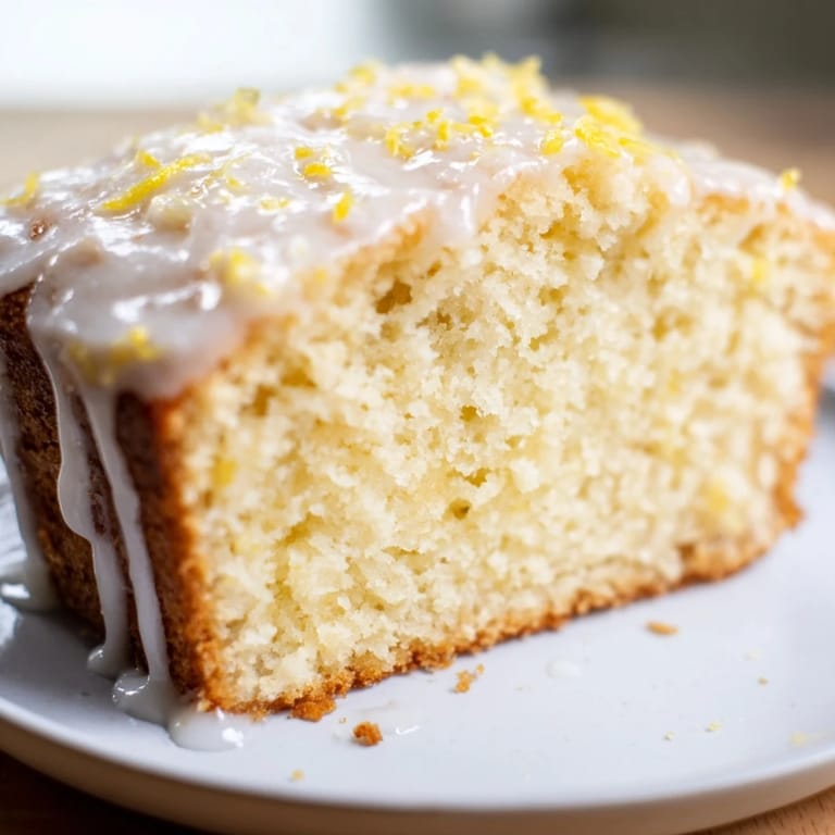Golden-brown Lemon Yogurt Cake, baked to perfection, offering a tangy bite for dessert or tea.