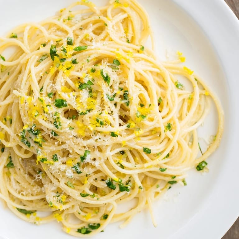 Bright, zesty Lemon Capellini, featuring angel hair pasta and a creamy lemon butter sauce.